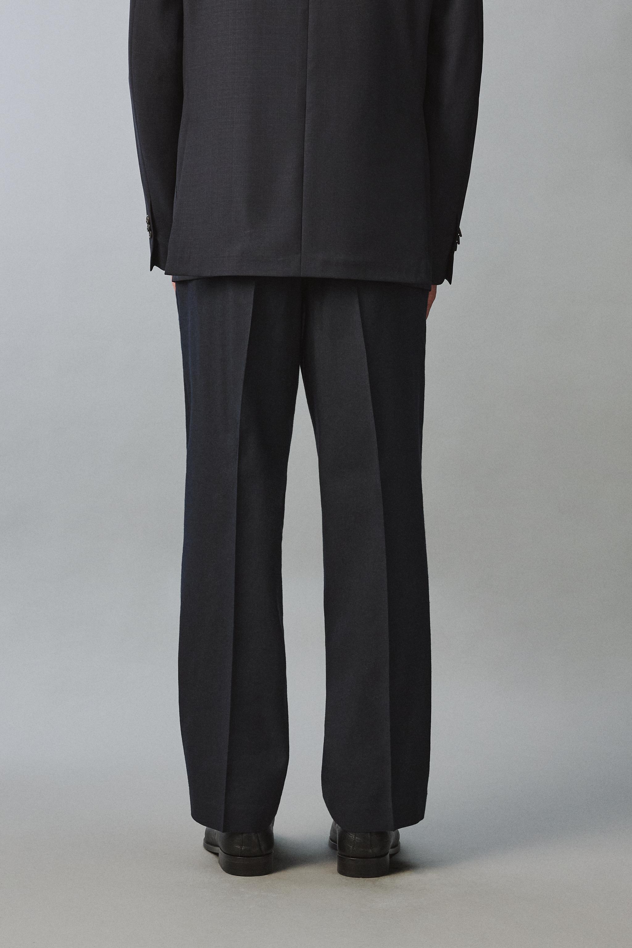100% WOOL RELAXED FIT PLEATED PANTS